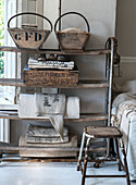 Old wooden shelf with vintage boxes and linen fabrics in the living room