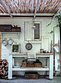 DIY outdoor kitchen under rattan canopy with vintage kitchen utensils