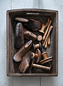 Vintage wooden box with old shoe lasts and thread spools