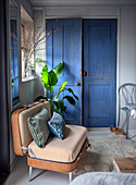 Vintage suitcase chair and blue wooden door in the cozy living room