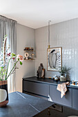 Modern kitchen with dark grey cabinets, marble worktop and white wall tiles