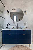 Modern bathroom with double washbasin and dark blue drawer fronts