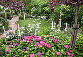 Romantic garden with hydrangeas and hanging chandeliers