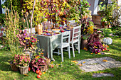 Autumnal table setting with plant arrangements in the garden