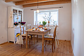 Dining room with table setting and spring-like decoration