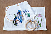 Embroidery hoop and embroidery thread with floral embroidery on linen fabric