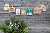 DIY Christmas cards on a wooden wall with winter decorations