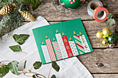 Christmas greeting card with candle motif on a rustic wooden table