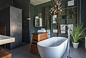 Modern bathroom with free-standing bathtub and green walls