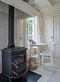 Black fireplace in a light-coloured room with white furniture