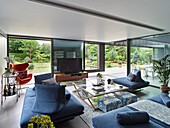 Modern living room with floor-to-ceiling windows and view of the garden