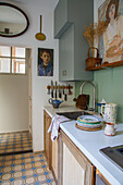 Small kitchen with vintage accessories and patterned tiled floor