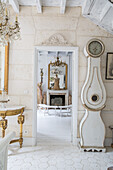 Baroque interior with antique grandfather clock and gold-look mirrors