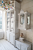 Display cabinet and wall mirror cabinet in country house style with crystal chandelier