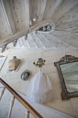 White wooden spiral staircase with rustic wall decor