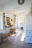 Bright living room in shabby chic style with antique furniture and accessories