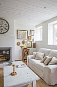 Living room with white sofa set and antique wall decoration