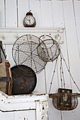 Vintage decoration with wire baskets and antique alarm clock on a white wooden wall