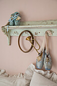 Vintage shelf with ballet shoes and horn on a pink-colored wall