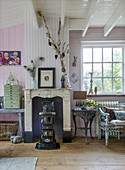 Vintage living room with rustic fireplace, wooden floor and nostalgic decoration