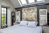 Bedroom with skylights and vintage-inspired wall panels