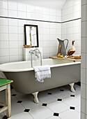 Freestanding bathtub in bathroom with retro charm