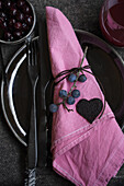 Sloe berries as napkin holder and heart made from sloe fruit leather
