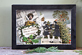 Vintage-style collage with angels and sheet music in a black frame