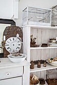 White furniture with birdcages and vintage clock in rustic decor