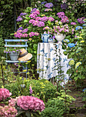 Table with hydrangea and tea service in the cottage garden