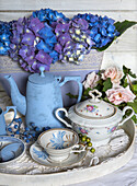 Vintage tea service with blue and purple hydrangeas on a tray