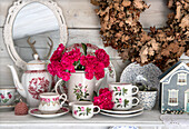 Tea service with floral motif, pink carnations and vintage mirror