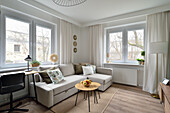 Brightly furnished living room with corner sofa and wooden accents in Nowa Praga, Warsaw