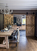 Rustic dining room with wooden sliding doors and chandelier