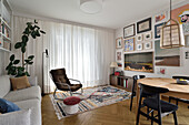 Living room with gallery wall, retro armchair and patterned carpet