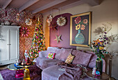 Living room with festively decorated tree and patterned wallpaper