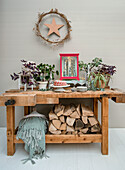 Workbench with plants, logs and Christmas decorations