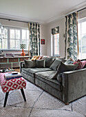 Living room with velvet sofa and patterned curtains