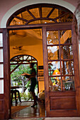 Wooden framed door opens to a cozy interior