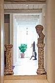 Country-style hallway with old columns and bust