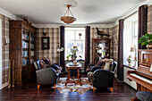 Traditional living room with checkered wallpaper, leather and wooden furniture and piano