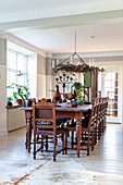 Dining room with antique dining table and chairs, chandelier and stuffed pheasants