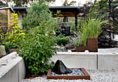 Zen garden with concrete walls and ornamental grasses