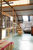 Industrial bedroom with metal bed and sheepskin chair on houseboat