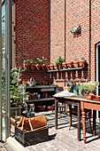 Plant corner with tables, shelves, sink and clay pots