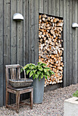 Garden area with wood storage, wooden chair and plant