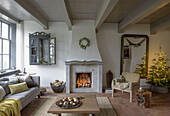 Cosy living room with fireplace, wooden beamed ceiling and Christmas decorations