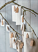 DIY advent calendar made from paper bags on branches