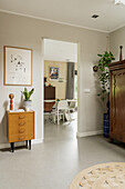 Retro-inspired hallway with wooden furniture and houseplants