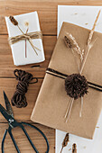 Gift wrapping with dried grasses and pompoms